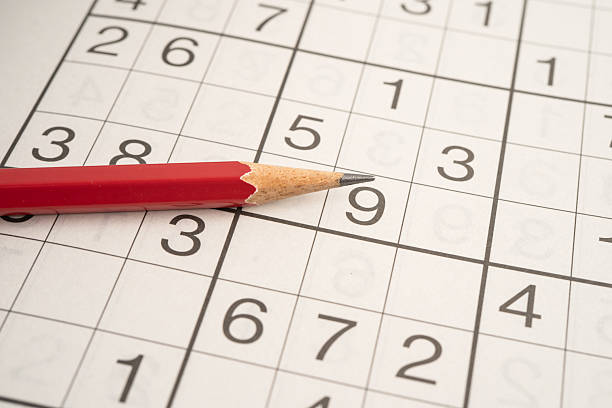 istock Sudoku puzzle game playing to challenge brain. 2219444440