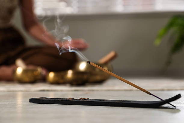 istock Incense stick smoldering in holder on floor indoors, selective focus 2219445546