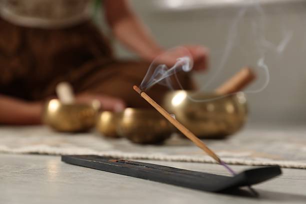 istock Incense stick smoldering in holder on floor indoors, selective focus 2219445617