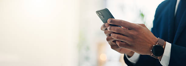 istock Hands, businessman and texting with phone in office of communication, schedule update and accountant. Person, mobile and reading corporate news, email feedback and financial report of investment chat 2219445951