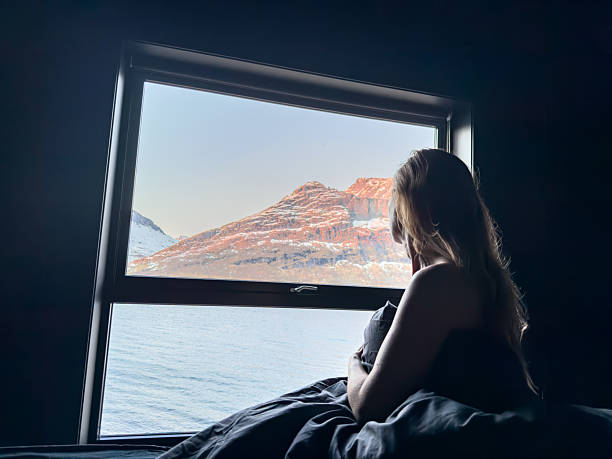 istock Woman Relaxing in Bed with Scenic Mountain View 2219446229