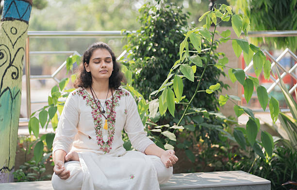 istock Young Woman in Traditional Indian Attire Practicing Mindfulness Meditation 2219446739