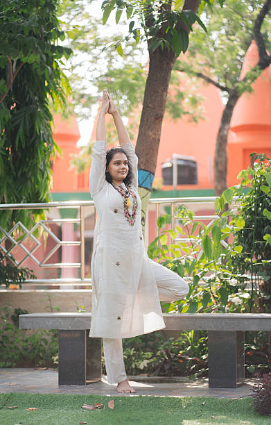 istock Mindful Balance – Woman in Tree Pose Outdoors 2219446943