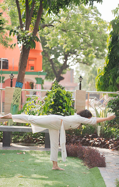 istock Young woman practicing yoga and meditation in forest setting 2219446984