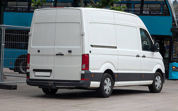 istock White van in the city – side view with empty space for advertising 2219449074