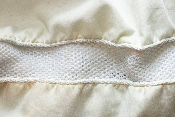 istock Light fabric pillow with a central insert of breathable mesh and soft folds 2219451079