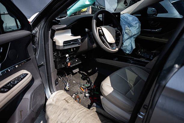 istock Interior of a vehicle with airbags deployed and disassembled dashboard view 2219451625
