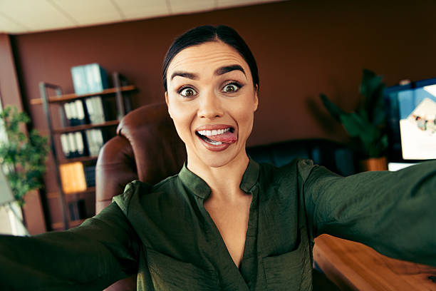 istock Confident businesswoman making a funny face while enjoying a unique moment in her professional office workspace 2219452476