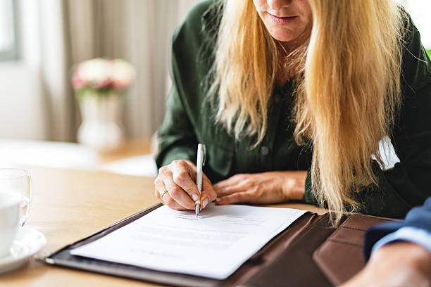 istock Caucasian Woman Signing Document in Office 2219452581