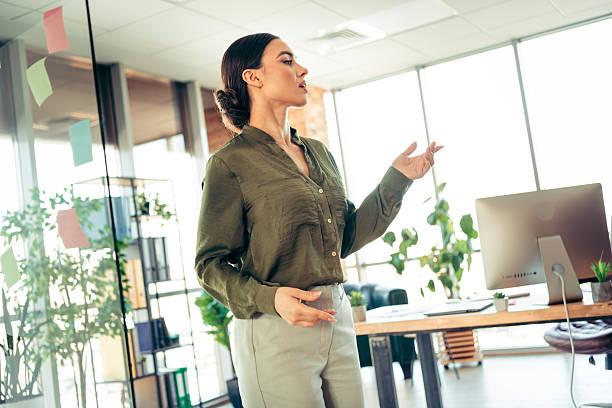 istock Confident businesswoman delivering a presentation in a modern office workspace 2219452598