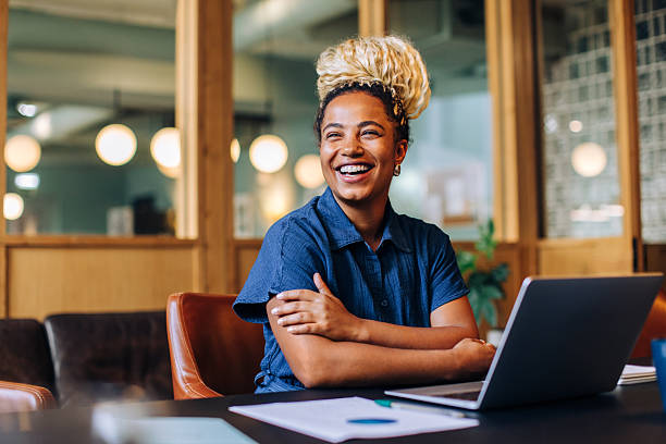 Young professional sitting at a desk with a laptop in an office