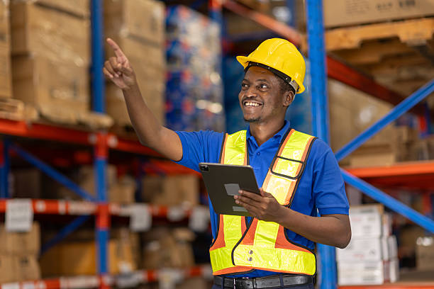istock African American man working in warehouse using tablet for stock checking counting stock at shelf 2219455490