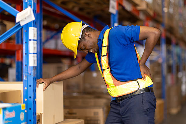 istock worker back pain, african male worker working in warehouse storage suffering from muscle problem 2219455493