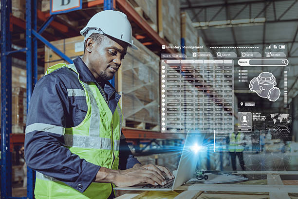 istock african black professional warehouse worker. stock inventory staff using computer check stock online 2219455512