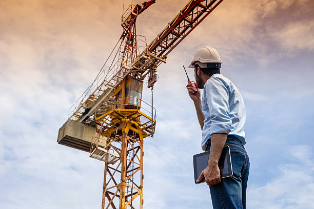istock Hispanic Indian professional construction engineer working operate Crane hoist in construction site 2219455528