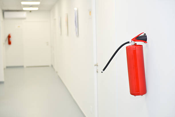 istock Red fire extinguisher. Close-up of red modern fire extinguisher in office 2219458748