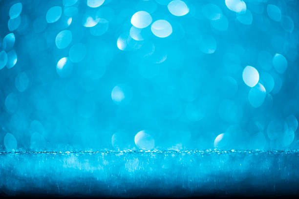 This defocused abstract background presents shimmering blue bokeh circles, frozen textures, and glowing sparkle. The soft focus shine adds elegance and cold romance, ideal for winter-themed celebrations, Christmas cards, New Year's Eve promotions, or party - social event visuals. Designed with glitter, light bursts, and copy space for use in web banners, wallpaper - decor, and seasonal slide shows.