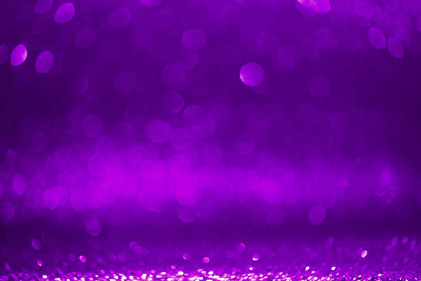 istock Royal-purple bokeh dusted with glitter sets a decadent stage for wedding invitations. 2219459147