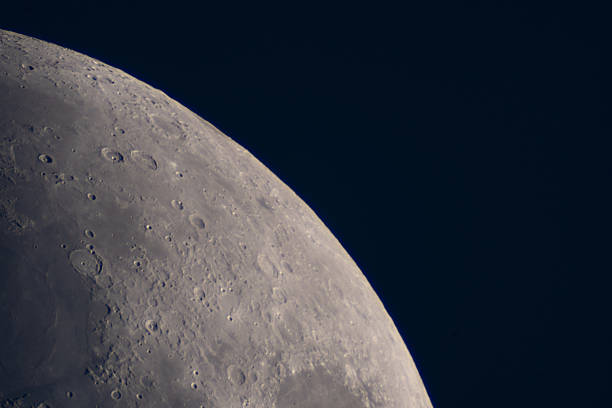 Partly illuminated moon in the dark night sky over Western Europe on January 18, 2024. The surface of the moon is clearly visible with various craters and seas.