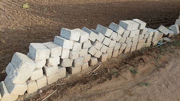 istock A rectangular stone or concrete block made from sandstone, sand, cement, and concrete, commonly used in modern construction across India and Pakistan for building walls, homes, offices, and commercial structures, offering greater durability than tradition 2219463978