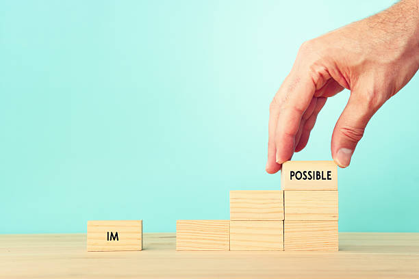 istock The word impossible is divided into two parts. success and challenge concept. 2219464939