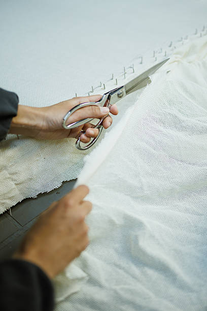 istock Cropped shot of craftswoman cutting canvas while doing carpet 2219468416