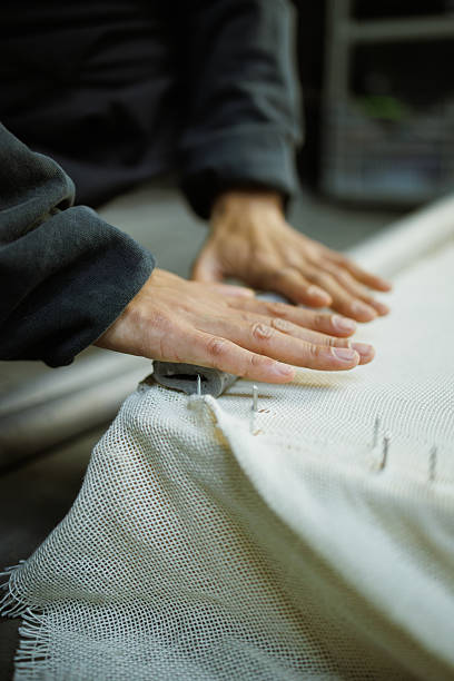istock Close up of craftswoman doing frame for carpet in workshop 2219468455