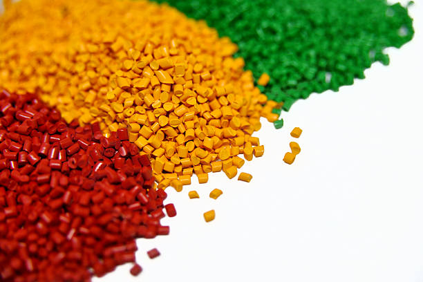 istock Red, yellow and green plastic granules on white background 2219474487