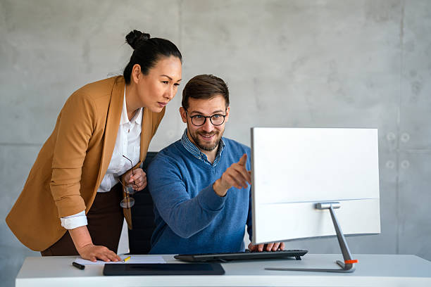 istock Business professionals collaborating on a project in a modern office. Team of coworkers sharing idea 2219475310