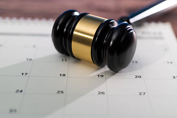 istock Wooden judge gavel on calendar 2219475334