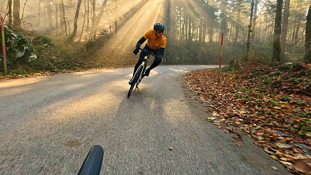 istock Cyclist rides downhill on a forest road 2219475409