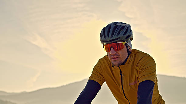 istock Cyclist in yellow rides through scenic mountains 2219475431