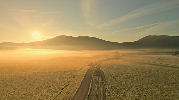 istock Sunset over fields and mountains, peaceful rural scene 2219475434