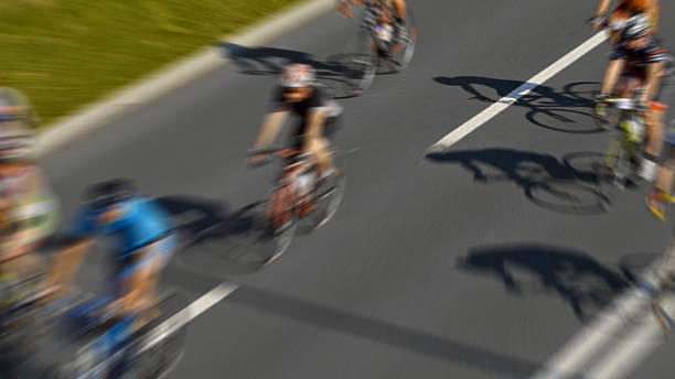 istock Bicyclists race down the street 2219475446