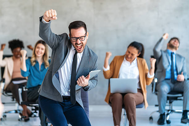 istock Group of young business people working as a team and communicating in corporate office 2219476295