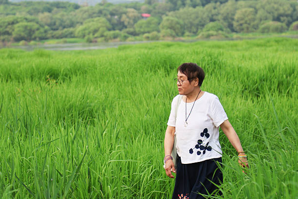 An elderly Asian woman in the park