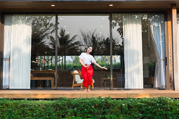 istock A young girl is practicing Thai traditional dancing at home. 2219477795