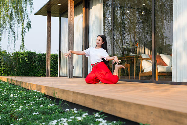 istock A young girl is practicing Thai traditional dancing at home. 2219478532