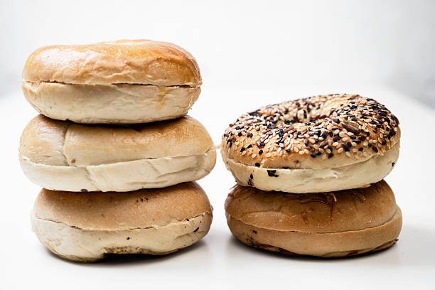 istock Closeup view of stack collection of bagel breads with various kind isolated over white background 2219479700