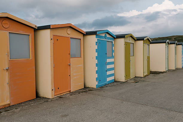 istock beach huts on the beach, England, UK 2219480277