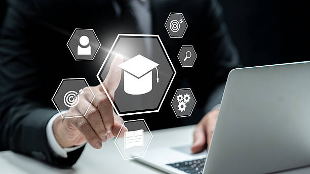 istock Businessman using a laptop while touching the graduation cap icon. Technology innovation on a virtual screen. Concept of E-learning education 2219480488