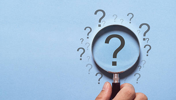 istock Hand holding magnifier glass with question mark for focus and concentrate in problem solving and solution concept. 2219483814