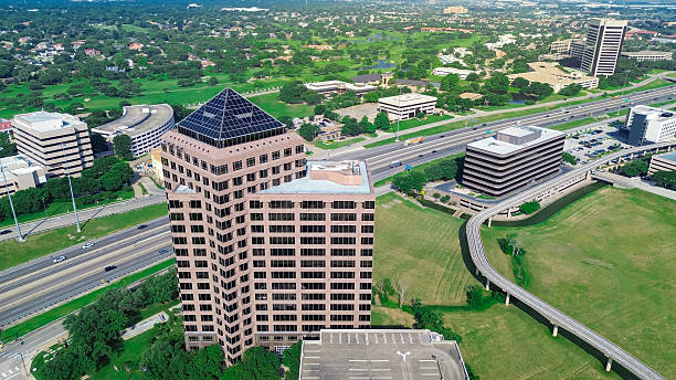 istock Light rail public transportation, busy John Carpenter Freeway, Texas SH 121 in downtown business district Las Colinas, Irving, high-rise corporate office buildings, residential house, golf course 2219484092