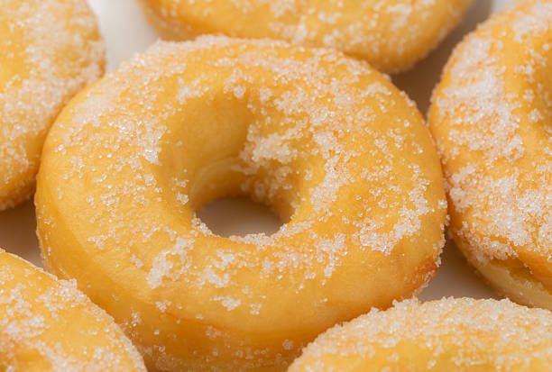 Sugar sprinkles donuts on white plate. Close-up view