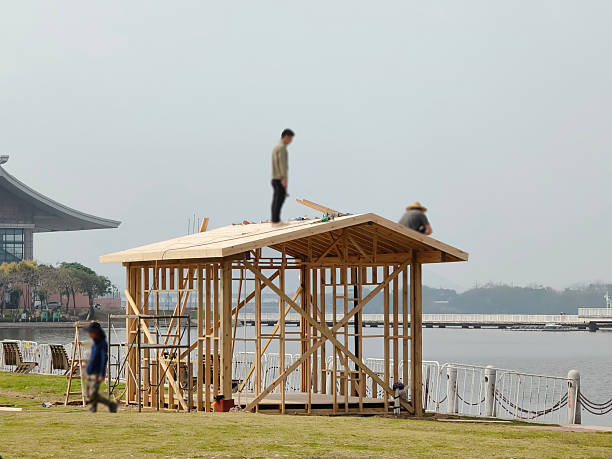 The carpenter is building a pavilion in the park