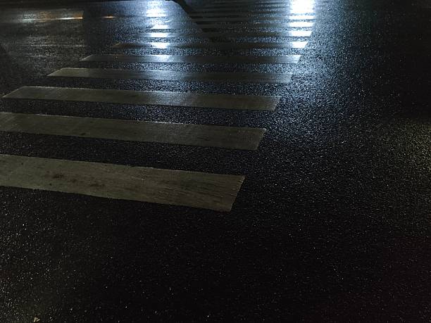 istock Zebra crossing looks wet at night because it has rained 2219487006