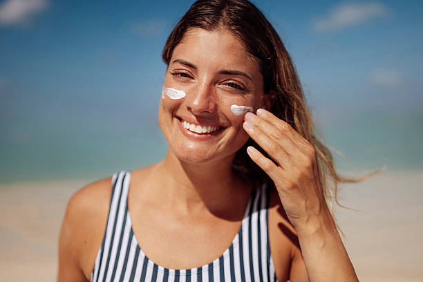 istock Woman Applying Sunscreen on Sunny Beach 2219487339