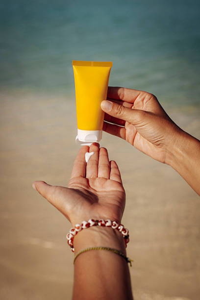 istock Close up of hands applying sunscreen 2219488039