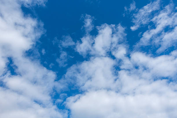 istock A serene view of fluffy white clouds scattered across a vibrant blue sky, creating a peaceful and tranquil atmosphereâperfect for nature, weather, or background themes. 2219494343