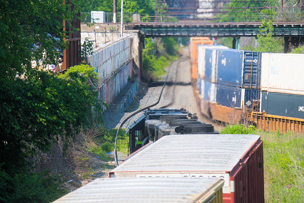 CSX intermodal train symbol I157 passing CP Nice in the Nicetown section of Philadelphia on a sunny day with Conrail train symbol MV-06